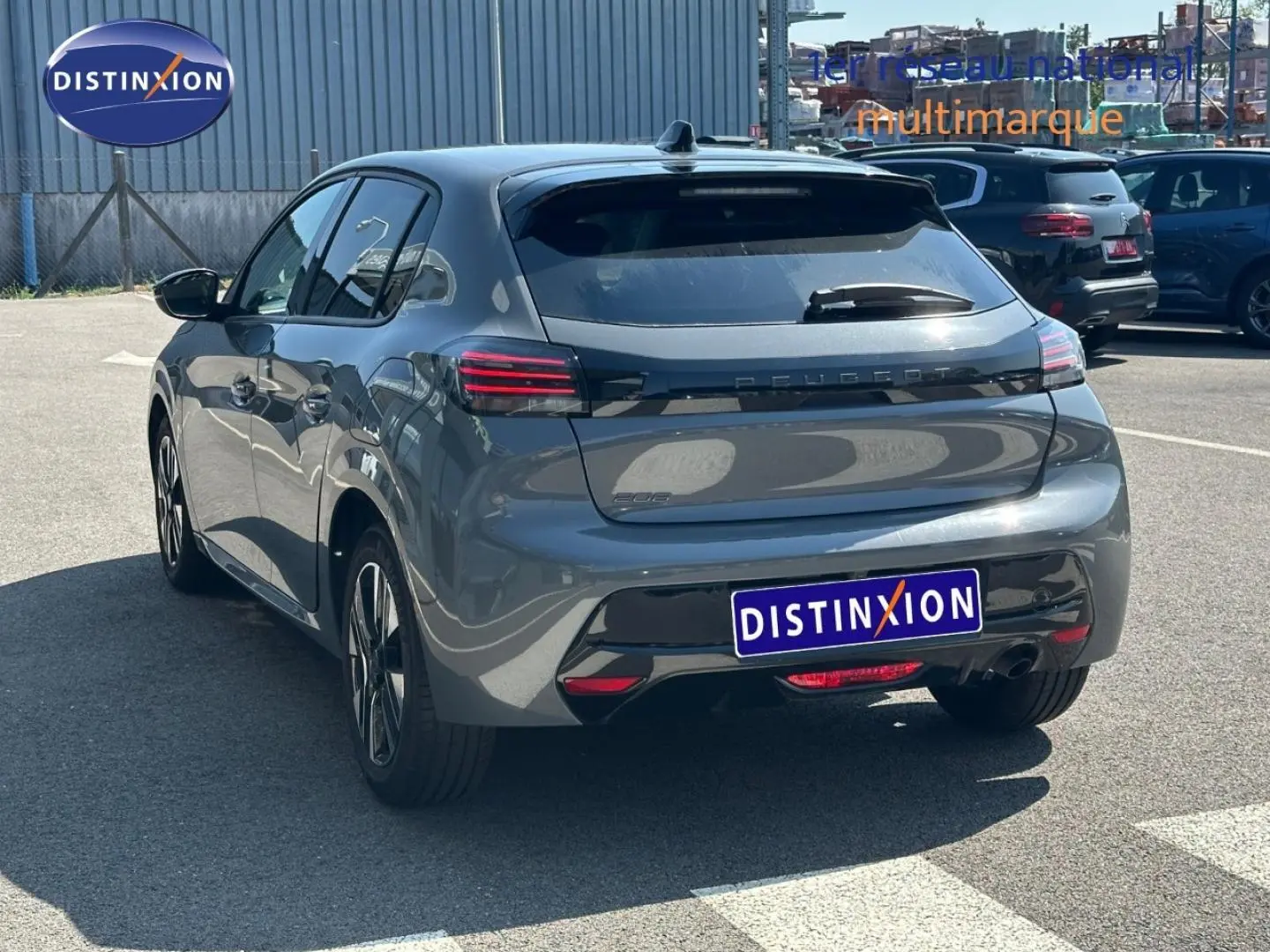 Vue 3/4 arrière droite d'une Peugeot 208 2025 gris Selenium avec feux arrière LED et jantes alu.