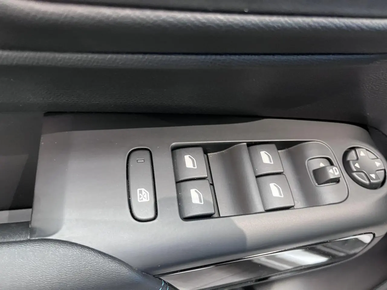 Gros plan sur les commandes de lève-vitres et rétroviseurs côté gauche d’une Citroën C5 Aircross gris platinium.