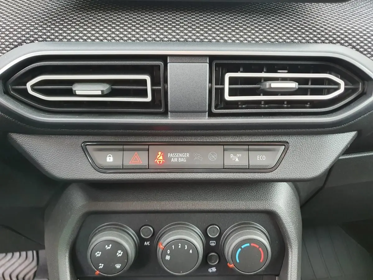 Détail de la console centrale du Dacia Jogger 2024, montrant les aérateurs et commandes de climatisation manuelle.