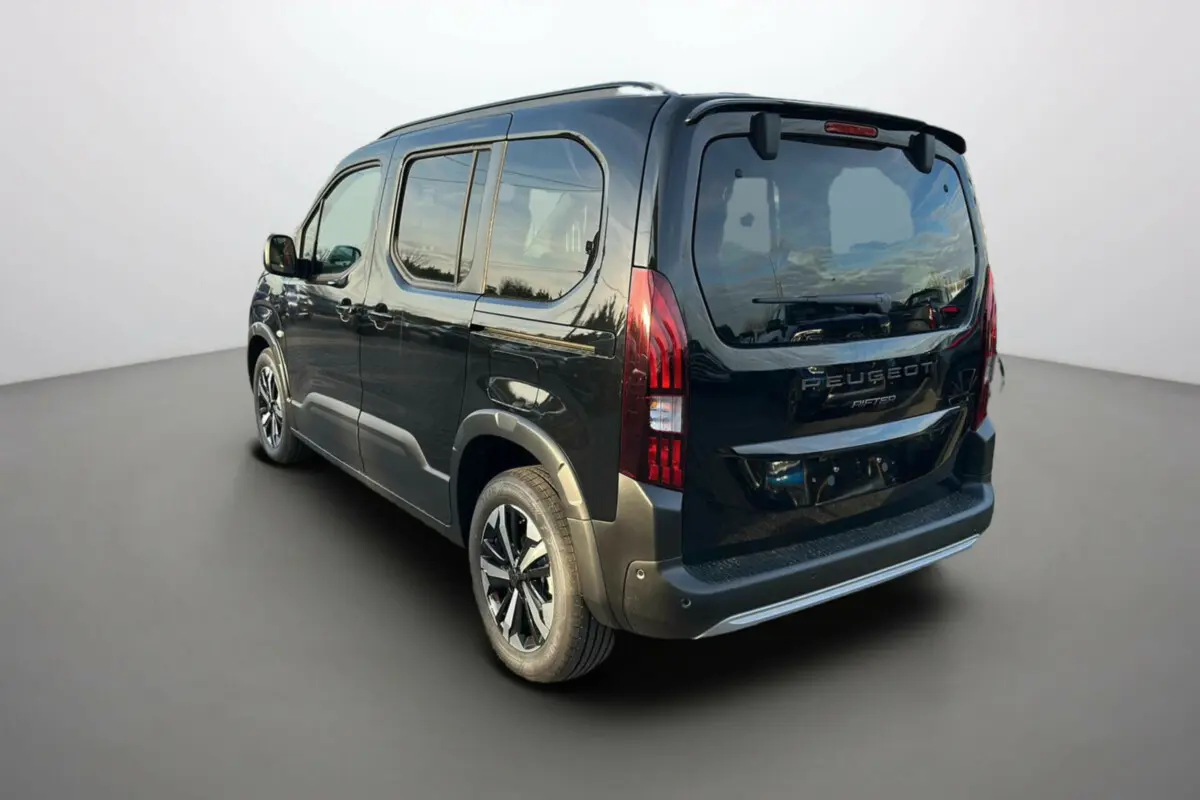 Vue 3/4 arrière droite du Peugeot Rifter noir perla nera avec vitres surteintées et jantes alu 17 pouces.