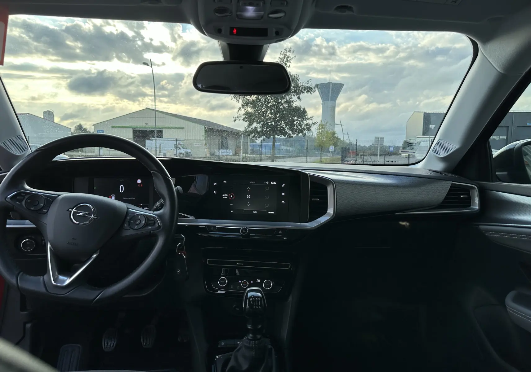 Intérieur de l'Opel Mokka Elegance 2021, vue frontale du tableau de bord avec volant, écran tactile et levier de vitesses manuel.