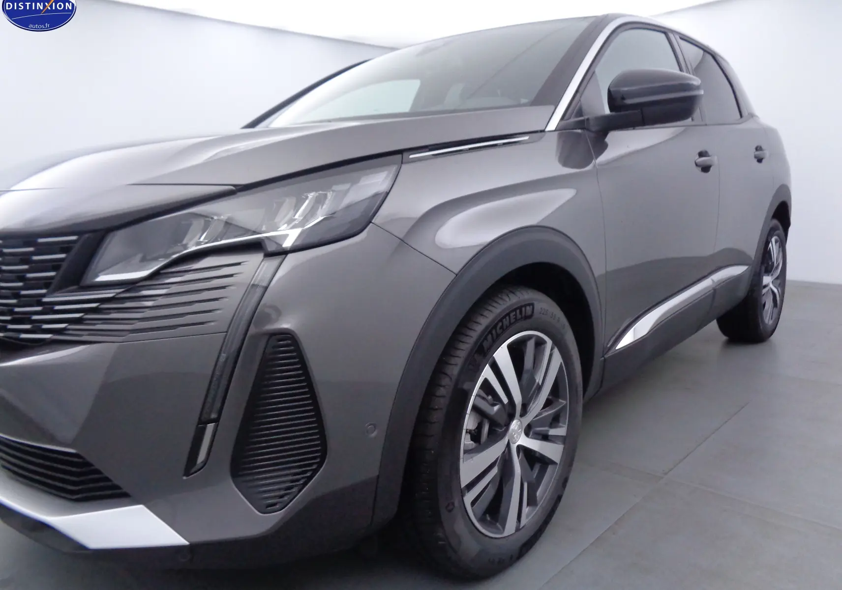 Vue 3/4 avant droit du Peugeot 3008 gris platinium métal avec ses phares LED et jantes alliage distinctives.