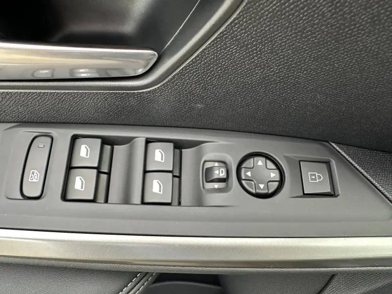 Panneau de commandes des vitres et rétroviseurs côté conducteur du Peugeot 3008 gris Titane, intérieur noir texturé.