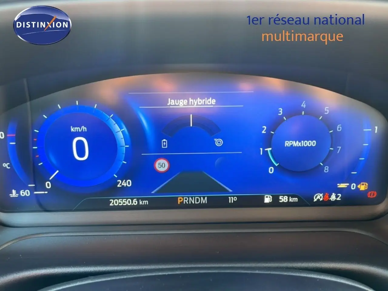 Tableau de bord numérique bleu du Ford Puma 2023, affichant jauge hybride, vitesse à 0 km/h et compte-tours.