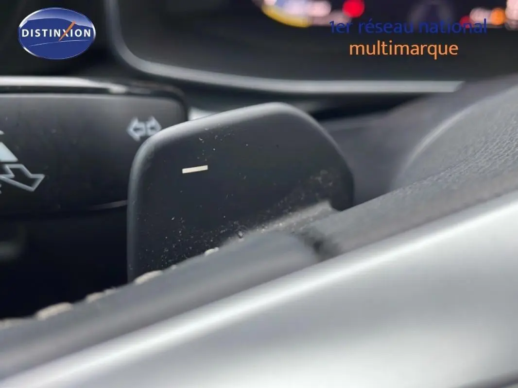 Gros plan sur la palette de changement de vitesse côté droit du volant cuir d’un SEAT Leon ST bleu 2025.