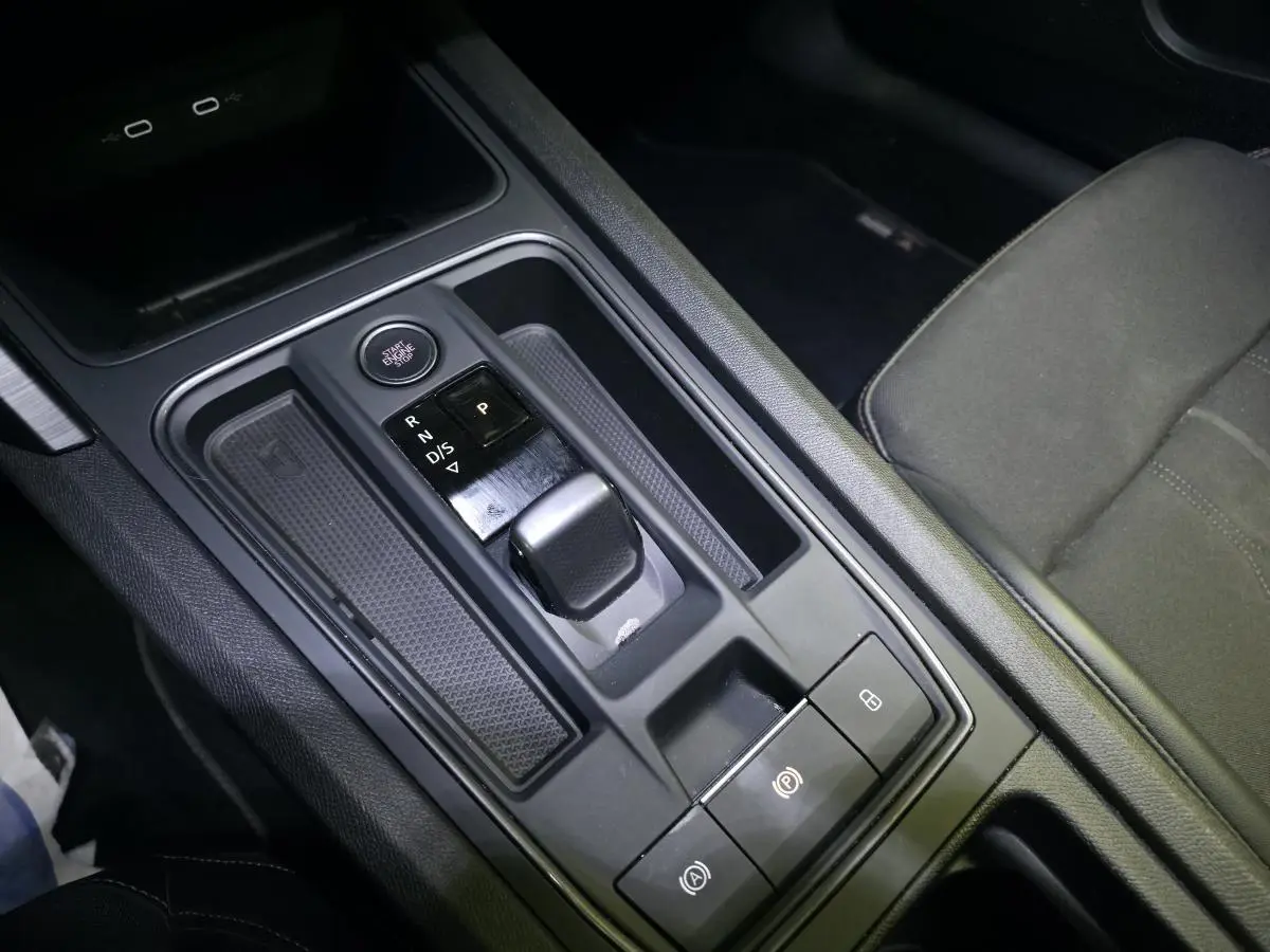 Gros plan sur la console centrale du CUPRA Leon Sportstourer gris, avec levier de boîte automatique et bouton start/stop.