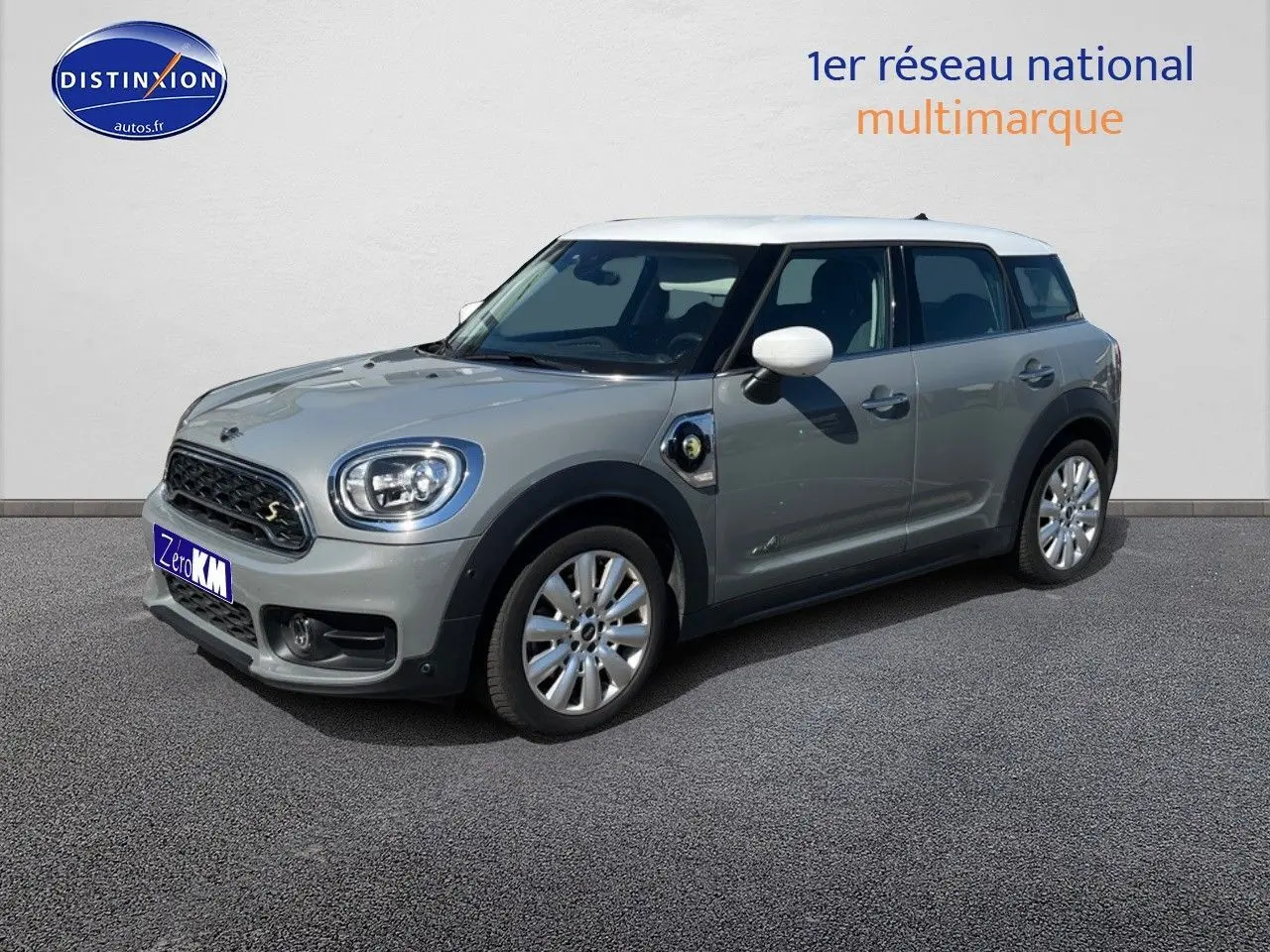 MINI Countryman hybride gris Moonwalk en 3/4 avant droit avec toit et rétroviseurs blancs sur fond neutre.