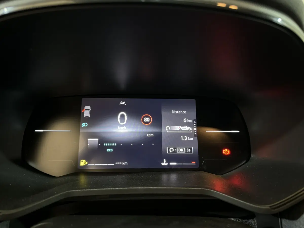 Combiné d'instruments numérique de la Renault Clio gris clair 2025 affichant vitesse, distance et alertes au tableau de bord.