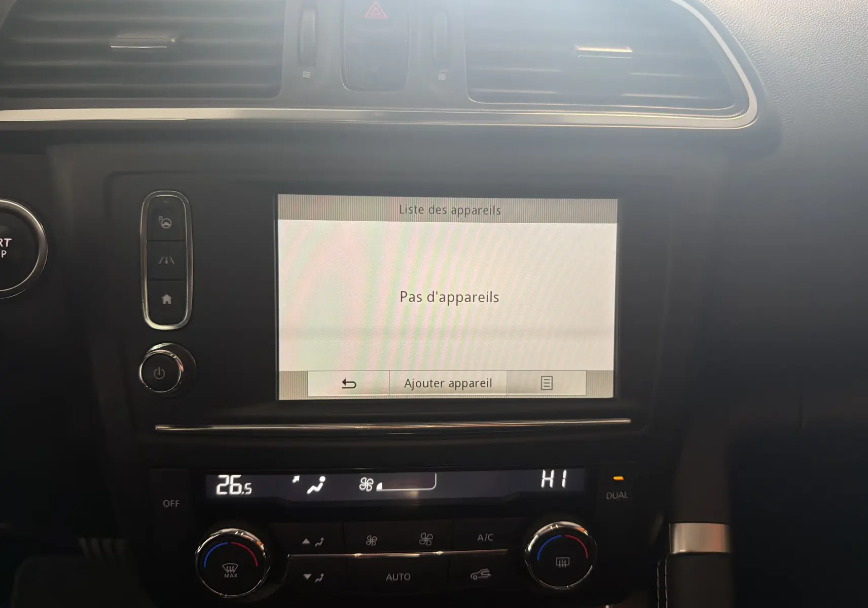 Vue rapprochée de la console centrale du Renault Kadjar gris, écran tactile affichant "Pas d'appareils" et commandes climatisation.