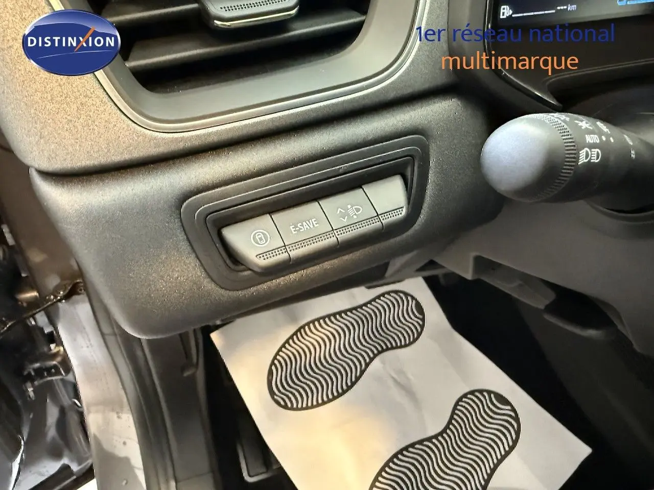 Vue intérieure côté conducteur du Renault Captur gris Cassiopée, montrant les commandes E-SAVE et réglage des phares.