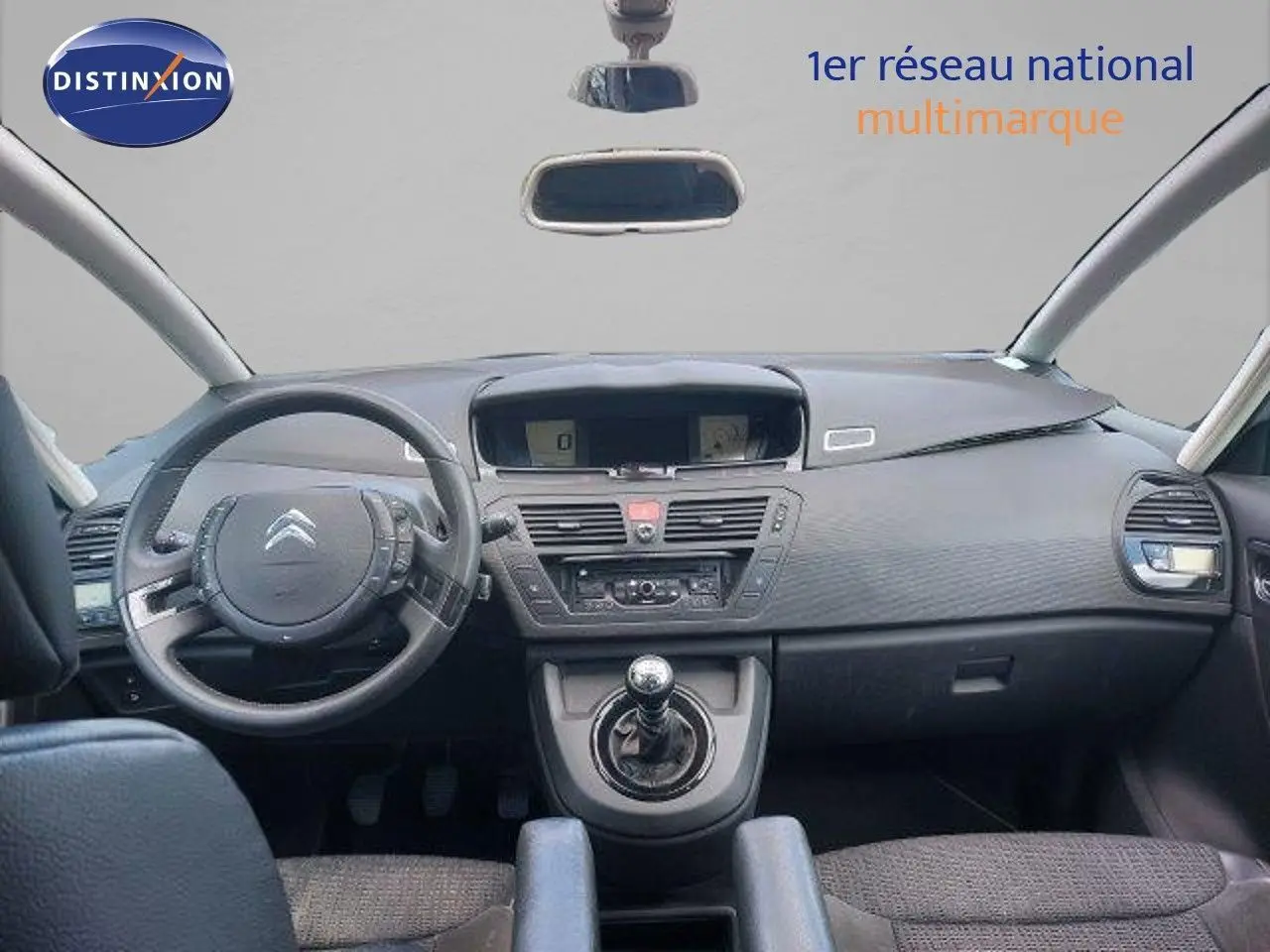 Intérieur de la Citroën C4 Picasso 2013, vue frontale du tableau de bord et levier de vitesse manuel gris.