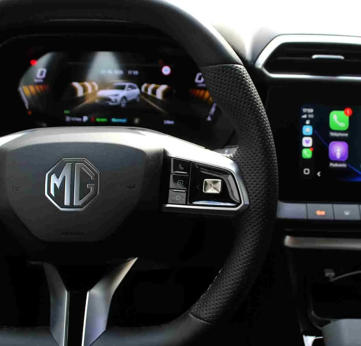 Vue rapprochée du volant perforé MG ZS 2026 avec commandes intégrées et tableau de bord numérique lumineux.