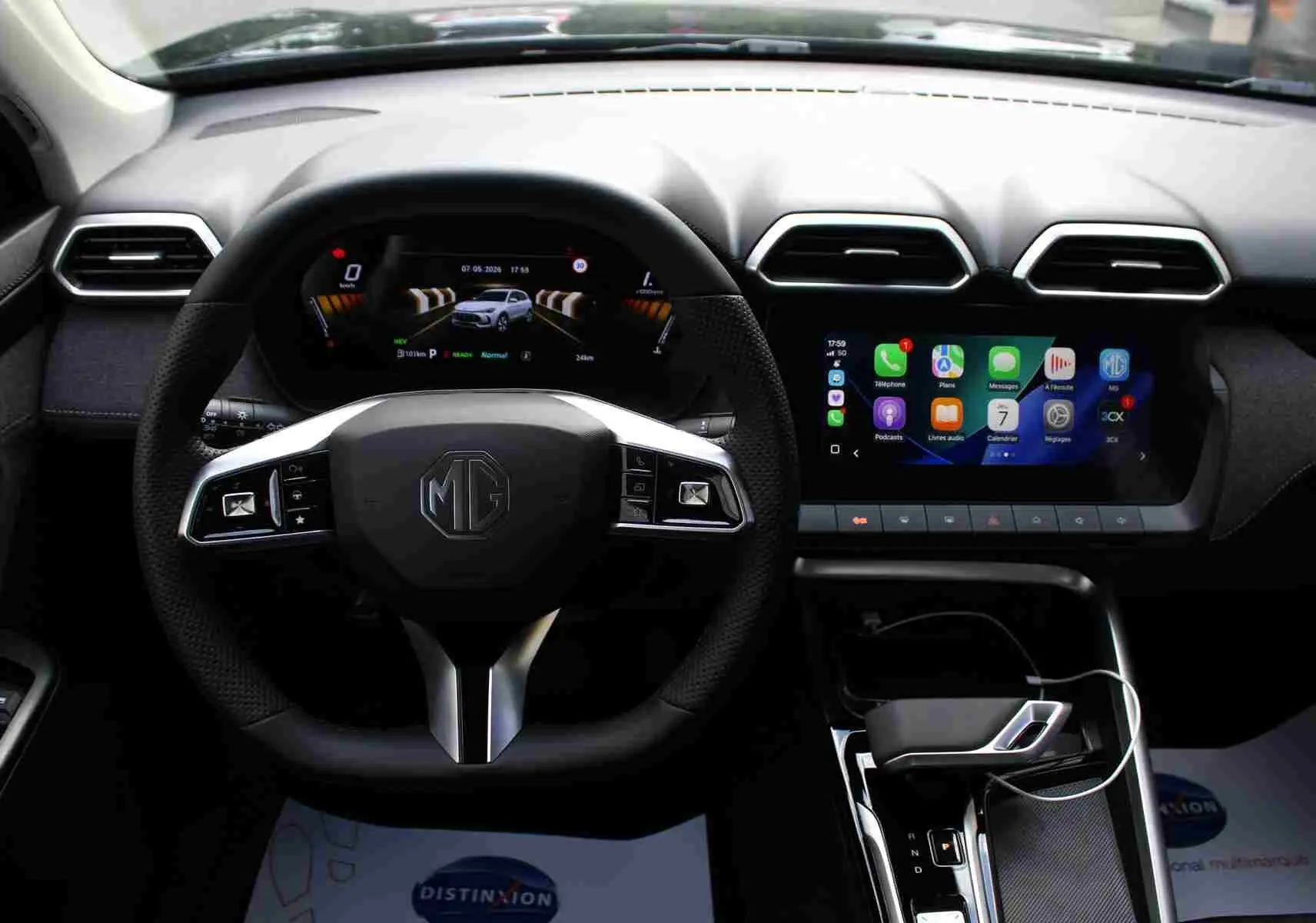 Vue plongeante sur la console centrale noire brillante du MG ZS 1.5L Hybrid+ avec levier de vitesse et commandes tactiles.