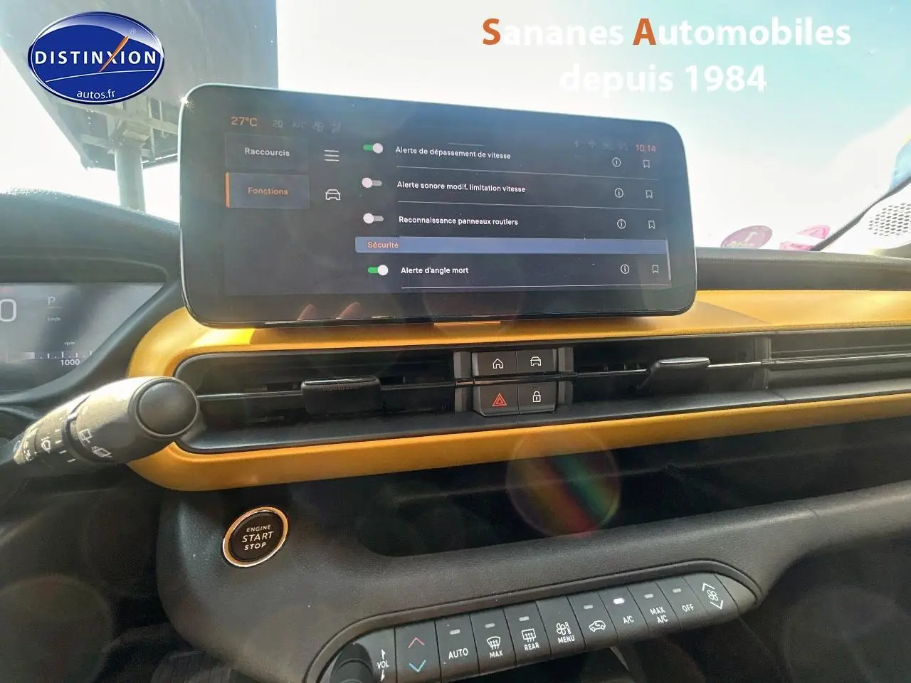 Vue intérieure du tableau de bord jaune foncé du Jeep Avenger 2025 avec écran tactile et bouton start/stop.