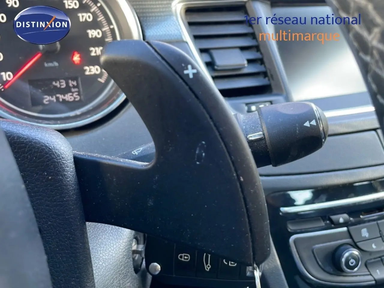 Gros plan sur la palette de changement de vitesse côté droit du volant d'une Peugeot 508 blanche de 2012.