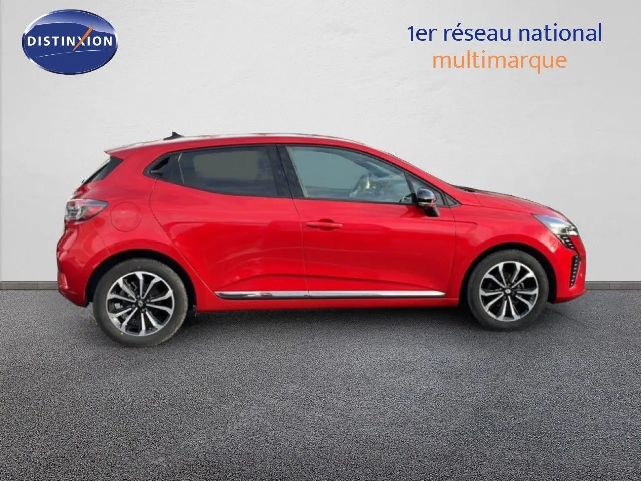 Profil droit de la Renault Clio 2025 rouge Désir Métal, finition Technno, avec jantes alliage et lignes chromées.