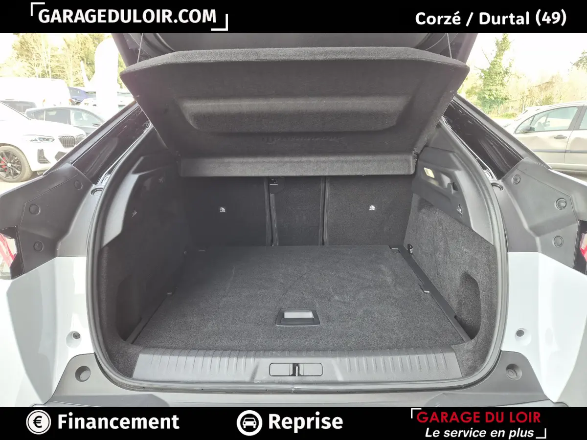 Coffre ouvert du Peugeot 3008 blanc, vue arrière montrant l'espace de chargement et la tablette de séparation.