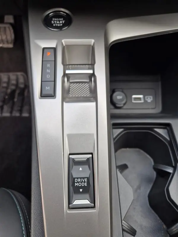 Vue rapprochée de la console centrale de la Peugeot 308 2024, avec levier de vitesses automatique et bouton Drive Mode.