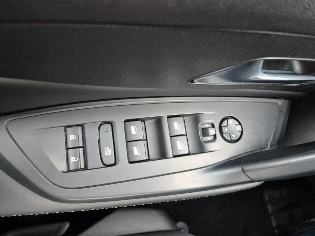 Panneau de commandes des vitres et rétroviseurs électriques côté conducteur dans une Peugeot 308 2024 finition Allure.