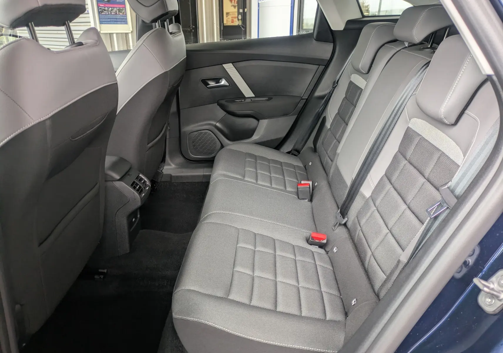 Écran tactile 10 pouces du tableau de bord de la Citroën C4 Hybrid 145 en vue frontale, affichant la climatisation à 20°C.