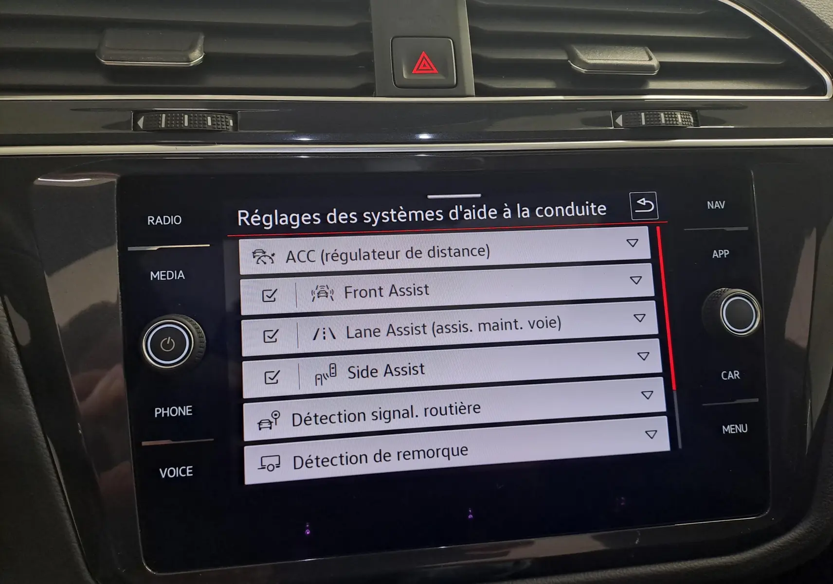 Écran tactile du tableau de bord du Volkswagen Tiguan 2024 affichant les réglages des aides à la conduite.