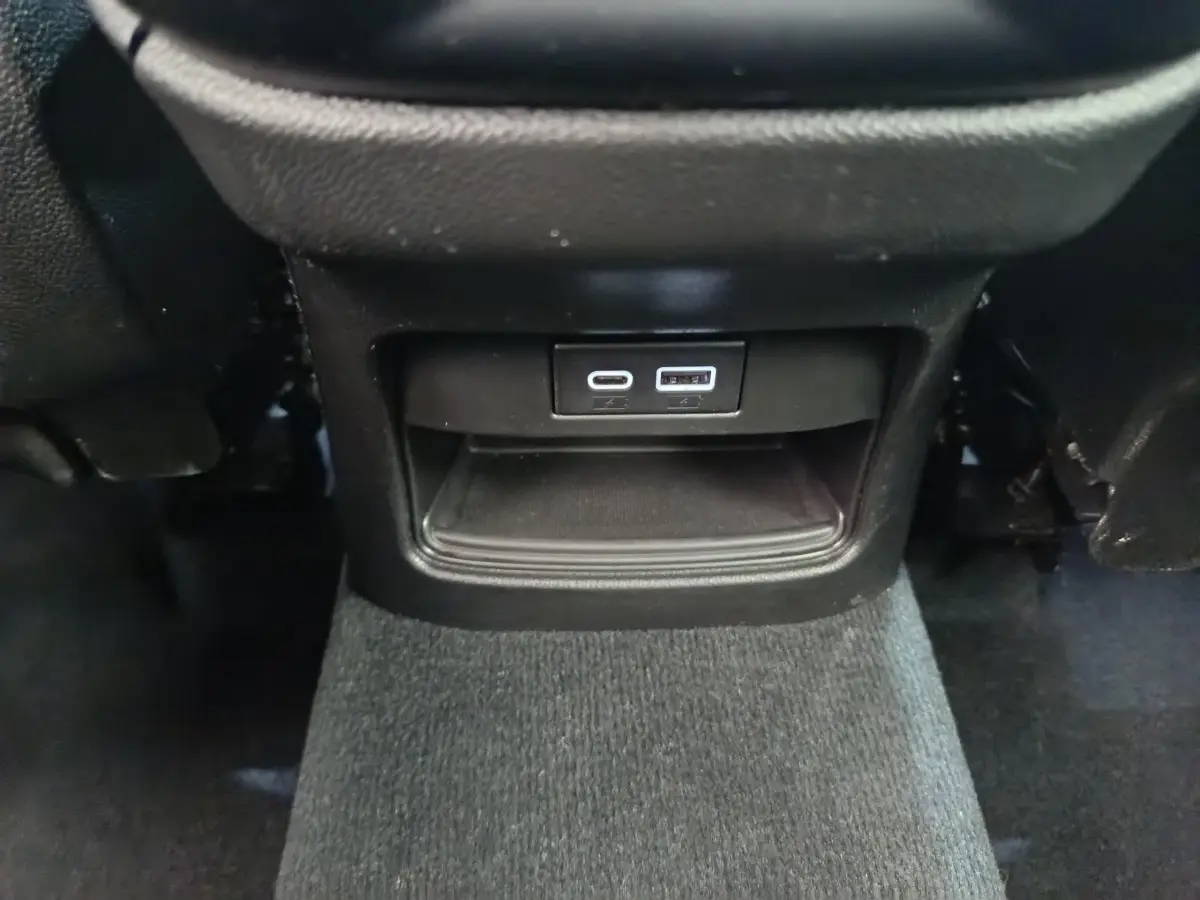Prise USB-C et USB-A en bas de la console centrale arrière d'un Alfa Romeo Stelvio gris foncé 2024.