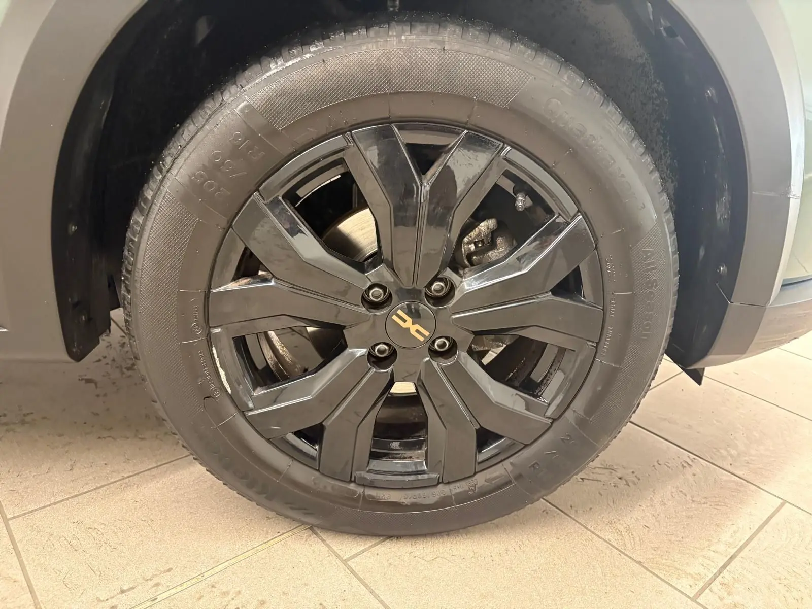 Gros plan sur la roue avant gauche avec jante noire brillante du Dacia Sandero Stepway Vert Cèdre 2023.