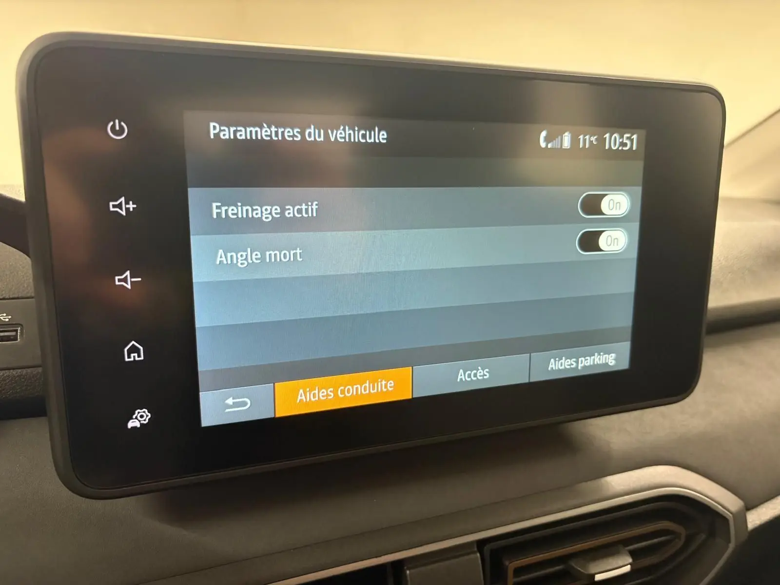 Écran tactile intérieur du Dacia Sandero Stepway 2023 montrant les paramètres d’aides à la conduite activées.