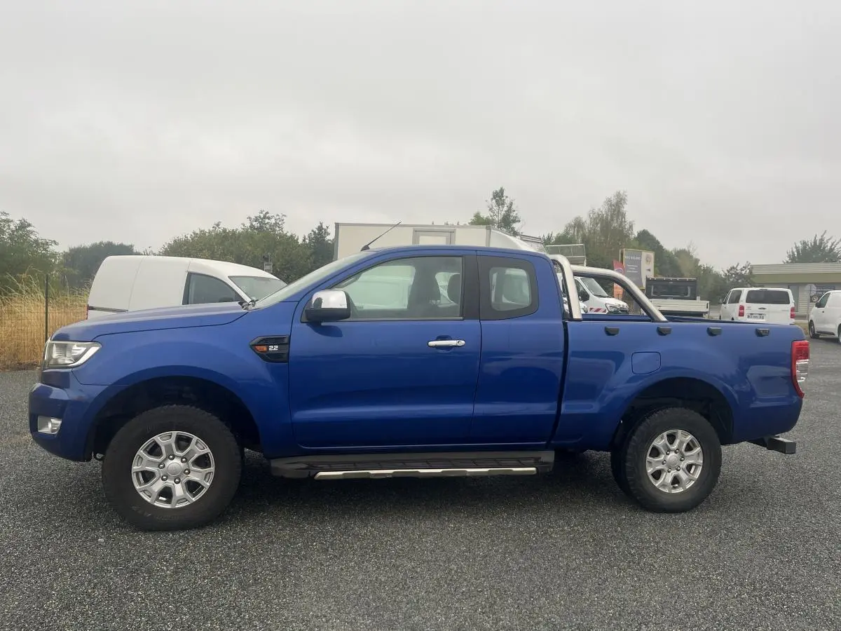 Profil côté gauche du pick-up Ford Ranger bleu 2019 avec super cabine, barres de protection et jantes alliage.