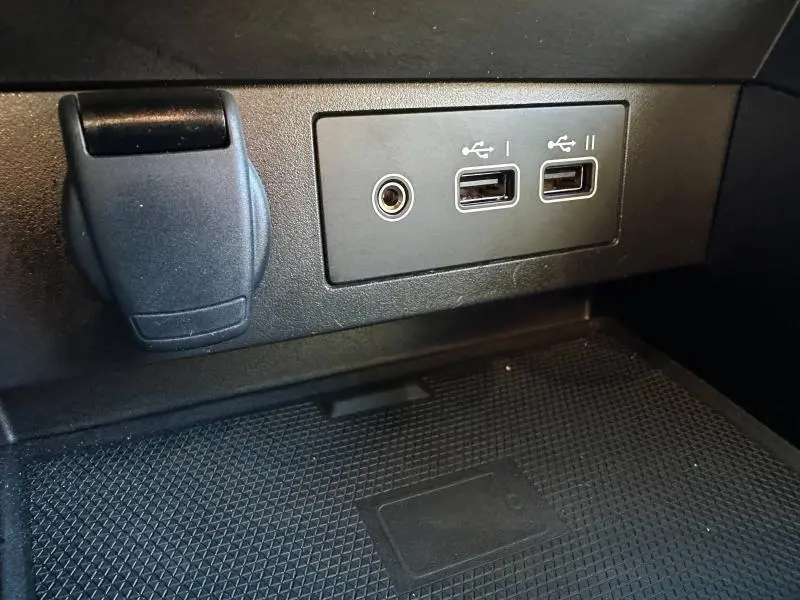 Gros plan sur les ports USB et prise jack dans l'habitacle de la Renault Clio 1.6 E-Tech Rouge Flamme, version hybride 2025.