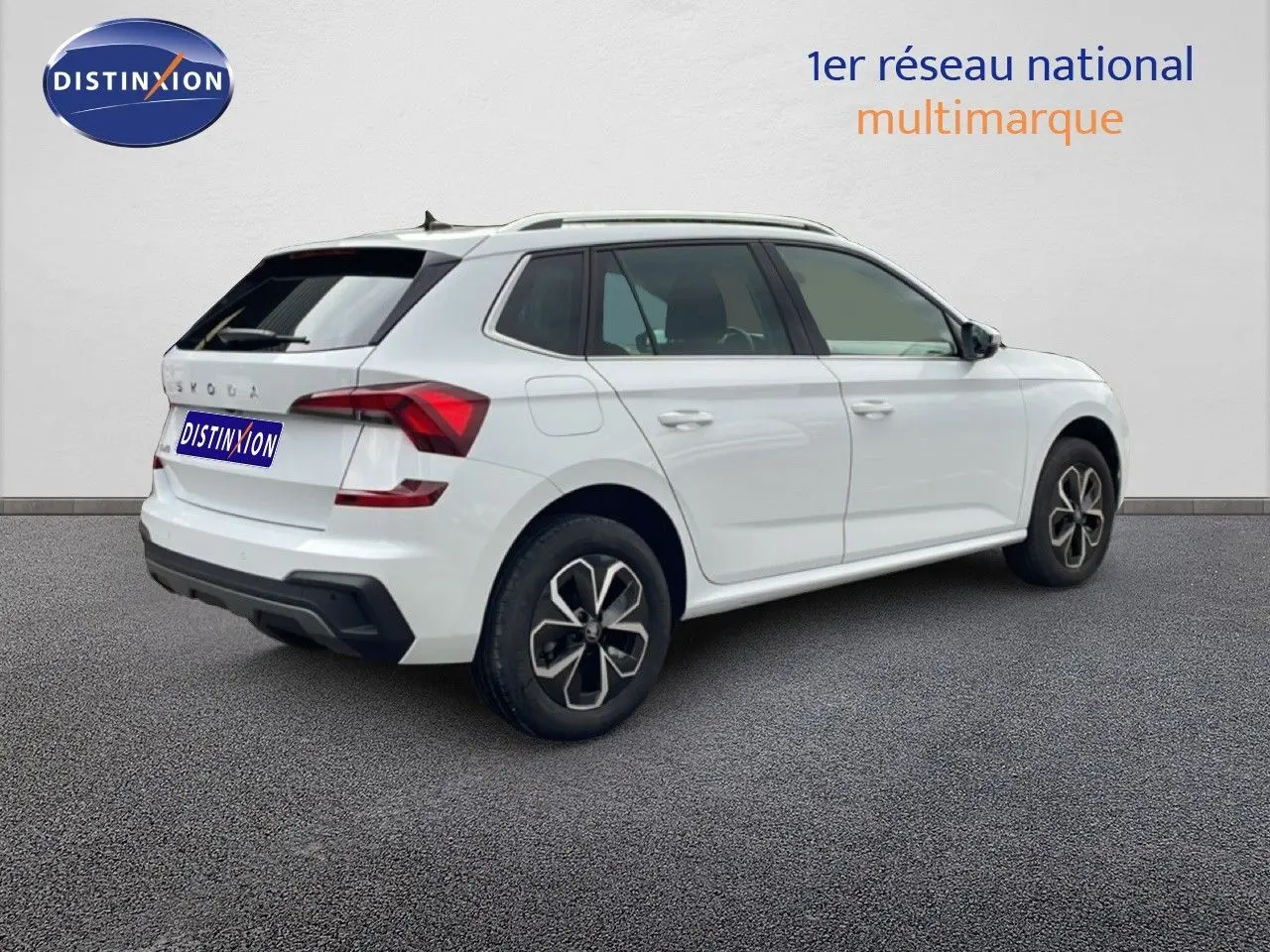 Vue 3/4 arrière droite d'un Skoda Kamiq blanc glacier 2025 avec jantes alliage et feux arrière LED distinctifs.