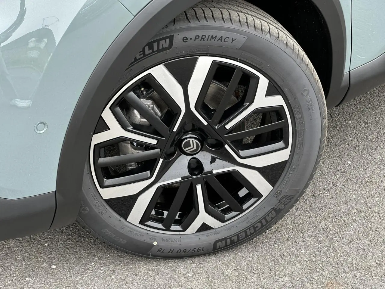 Gros plan sur la jante alliage 18'' AMBER diamantée noire et argentée du côté avant gauche d'une Citroën C4 Manhattan Green.