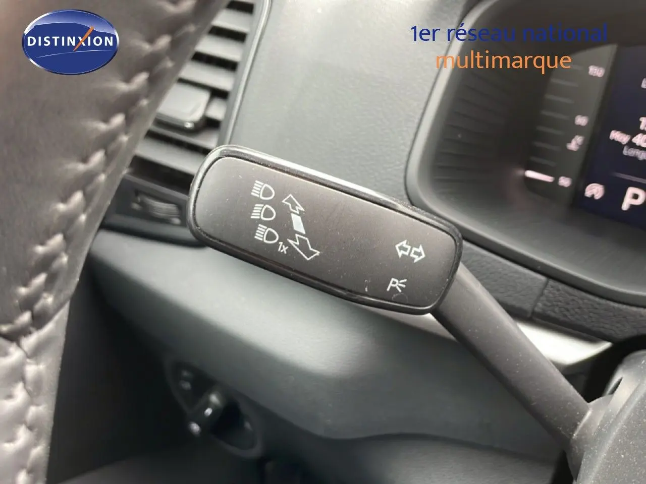 Gros plan sur la manette de clignotant à gauche dans l’habitacle d’un Skoda Karoq blanc glacier 2025.