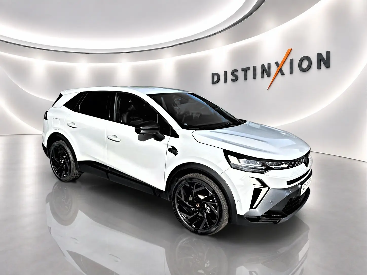 Renault Symbioz gris rafale en 3/4 avant droit, SUV hybride avec jantes noires et détails noirs contrastants.