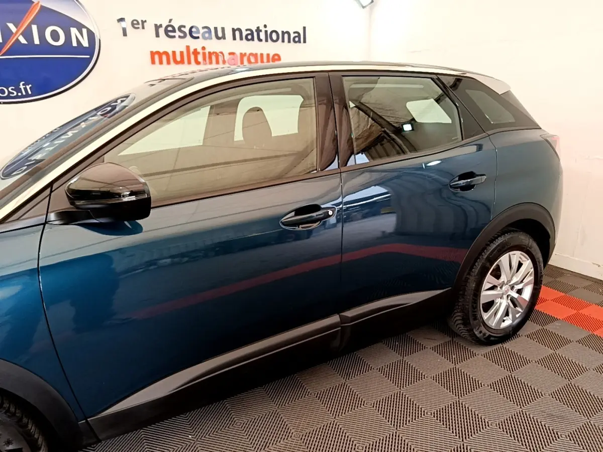 Vue latérale gauche du Peugeot 3008 bleu 2022 dans un showroom avec jantes argentées et rétroviseurs noirs.