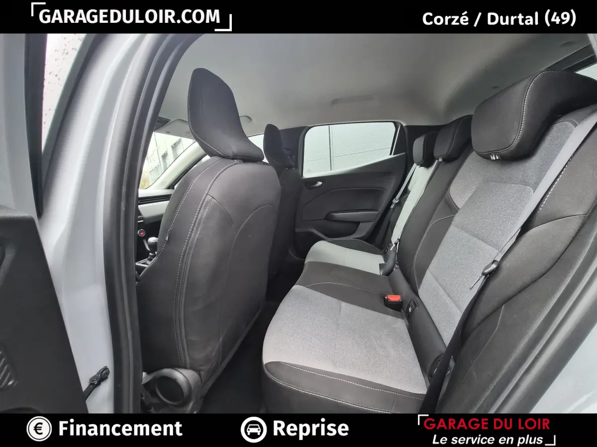 Vue intérieure arrière côté gauche de la Renault Clio gris clair, montrant la banquette bi-ton et les dossiers des sièges avant.