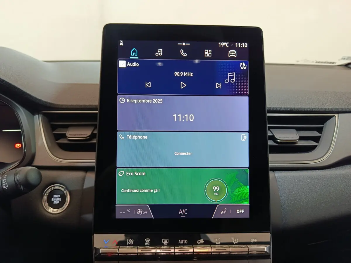 Vue rapprochée du tableau de bord central tactile du Renault Captur blanc 2025 avec écran multifonctions vertical.