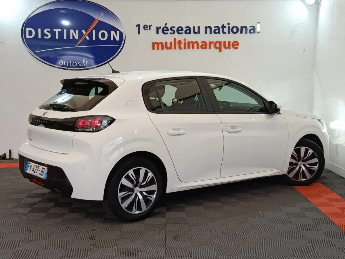 Peugeot 208 PureTech 100 blanc vue 3/4 arrière droit, feux LED et jantes alliage distinctives visibles