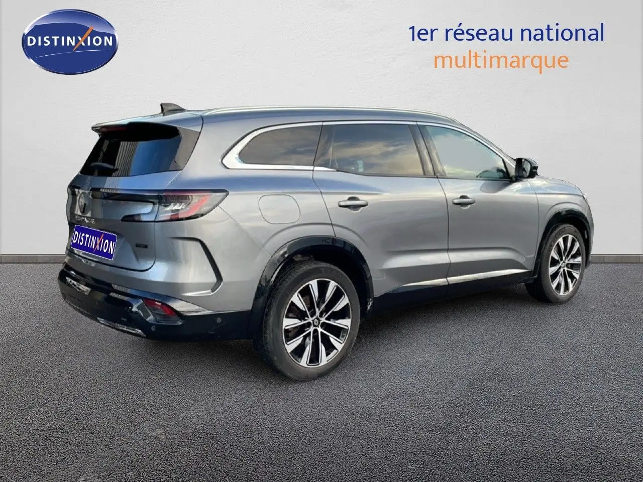 Vue 3/4 arrière droite d’un Renault Espace 2024 gris schiste métallisé avec jantes alliage et vitres teintées.