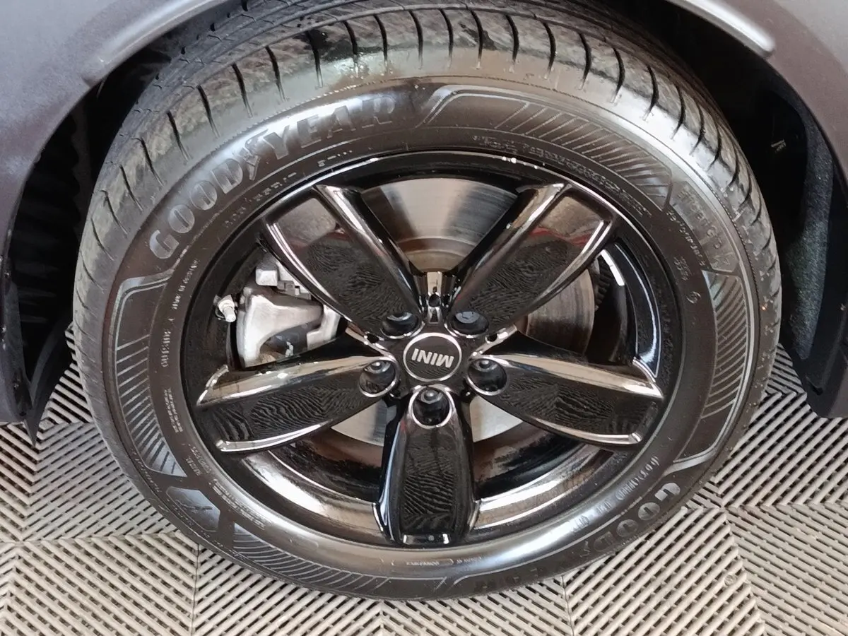 Gros plan sur la roue avant droite noire brillante d’un MINI Countryman Cooper SE 2023 avec pneu Goodyear.