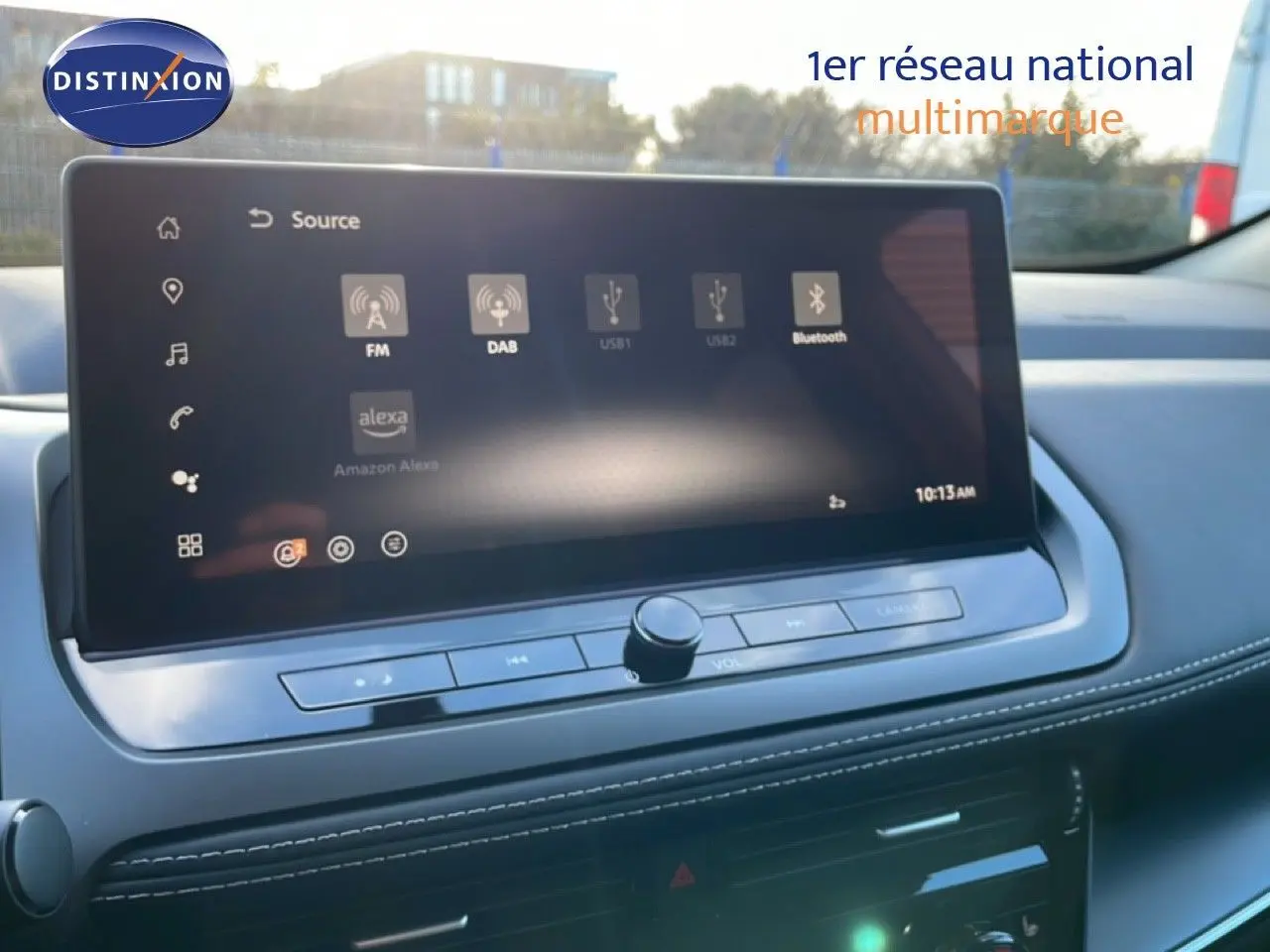 Écran tactile central du Nissan Qashqai 2025, affichant les sources audio avec commandes intégrées, intérieur gris clair.