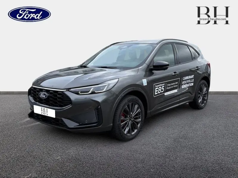 Ford Kuga gris Magnetic en 3/4 avant droit avec marquages E85 sur porte et jantes noires.