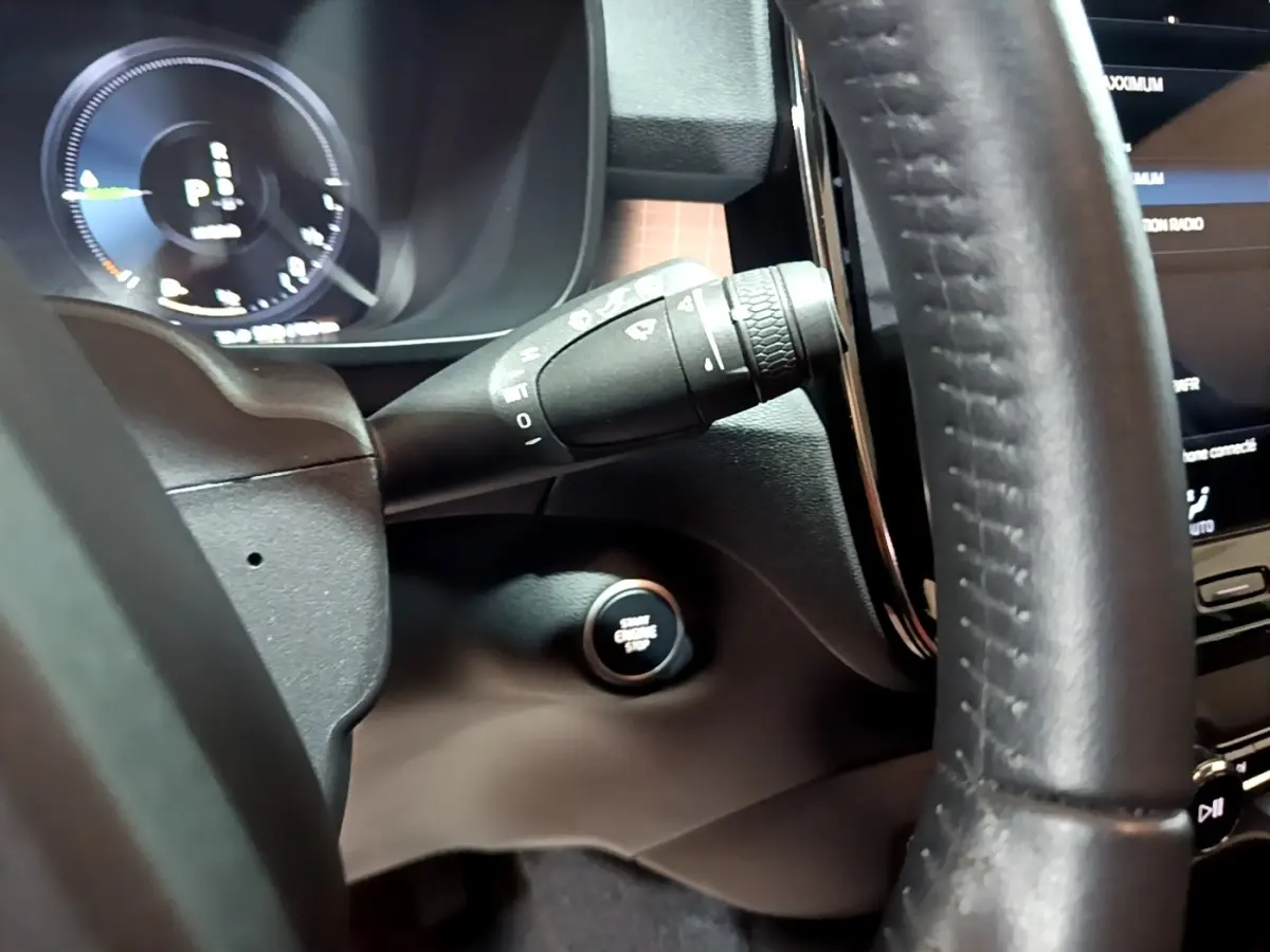 Détail intérieur du Volvo XC40 Recharge T4 2020 montrant le volant cuir, la commande essuie-glace et le bouton démarrage start/stop.