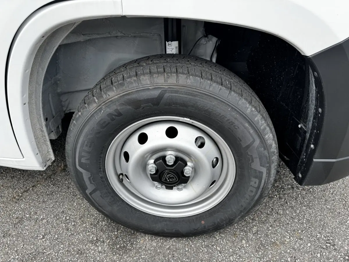 Gros plan sur la roue avant droite du Peugeot Boxer Fourgon blanc, jante acier et pneu Nexen visible.