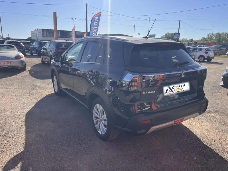 Vue 3/4 arrière droite d'un Suzuki S-Cross 2024 noir Cosmic Black Pearl métallisé avec feux arrière LED et jantes alu.