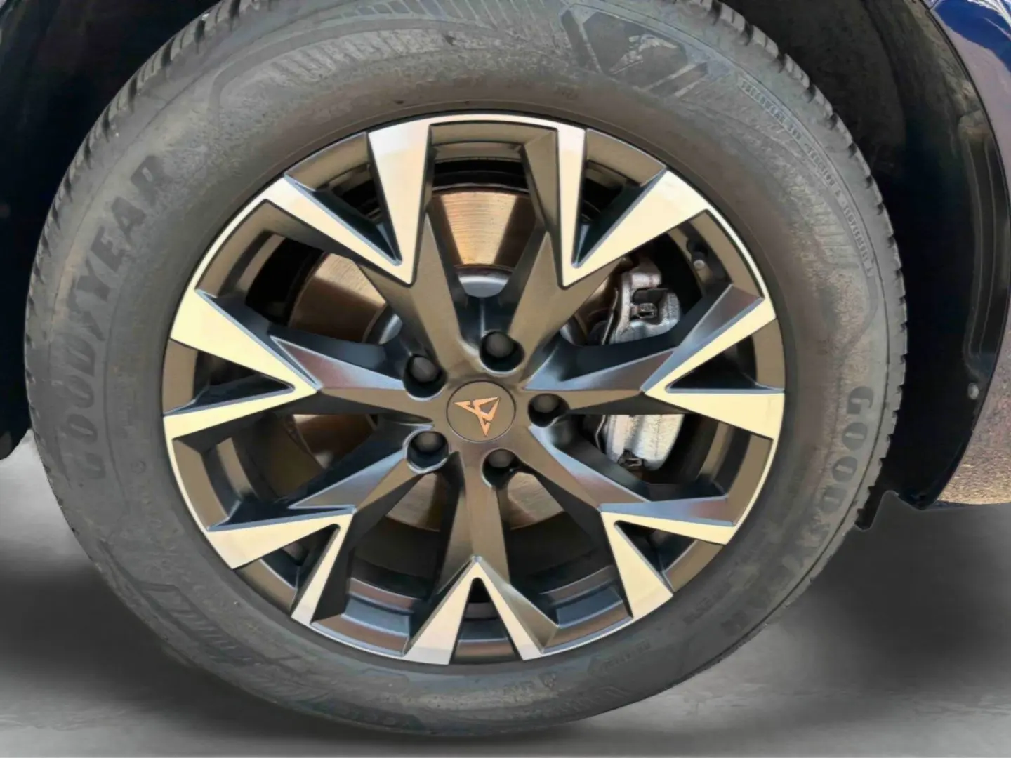 Gros plan sur la jante alliage bicolore avec logo CUPRA au centre, montée sur pneu Goodyear du CUPRA Terramar bleu.