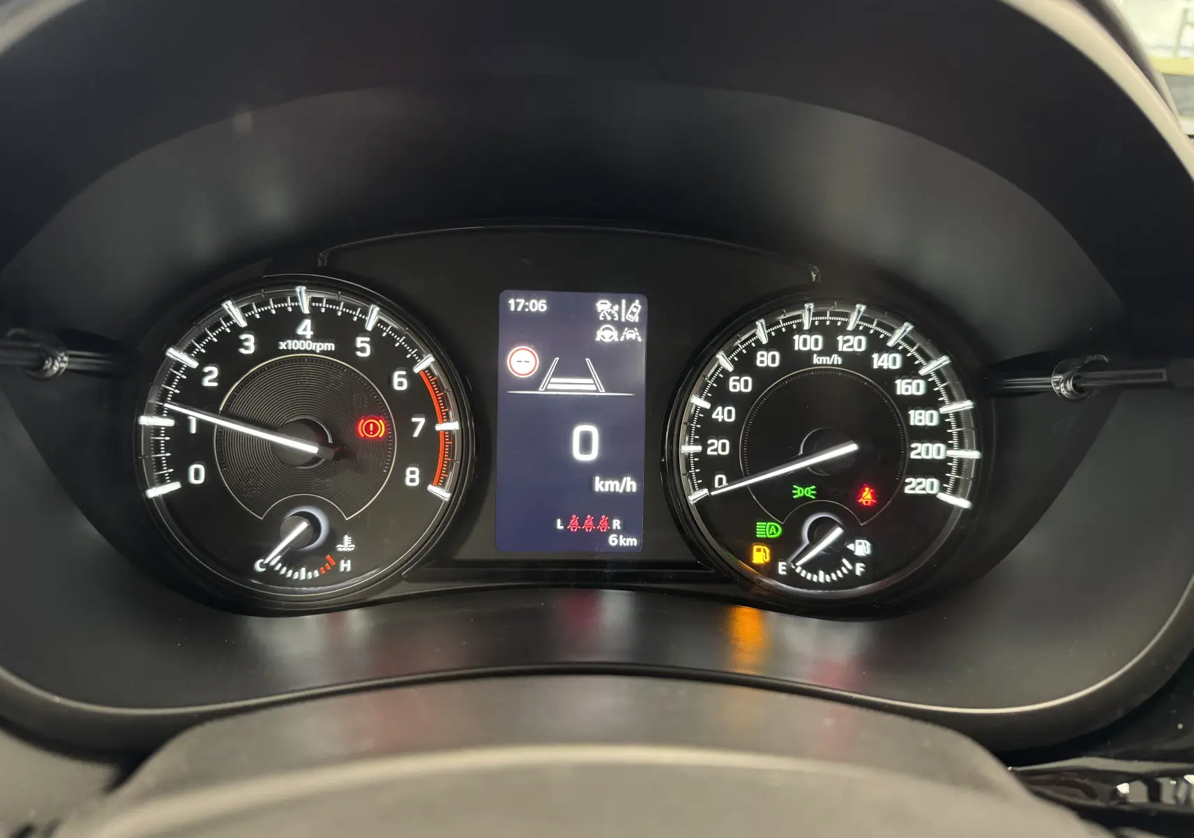 Vue rapprochée du tableau de bord du Suzuki S-Cross gris 2025, affichant compte-tours, vitesse et voyants allumés.