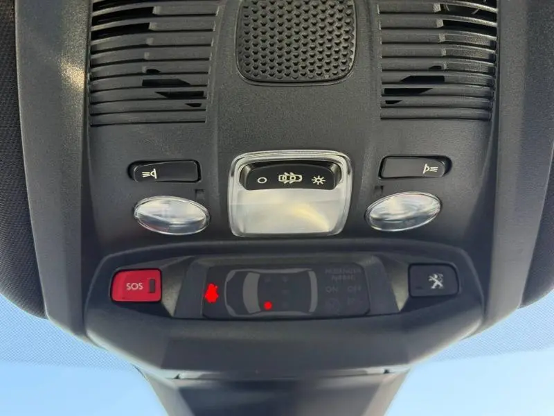 Vue en gros plan du plafonnier intérieur du Peugeot 3008 Gris Platinium, avec boutons d'éclairage et alerte SOS visibles.
