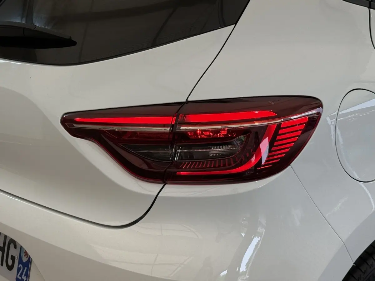 Gros plan sur le feu arrière droit rouge d’une Renault Clio blanche Evolution TCe 100 GPL de 2023.