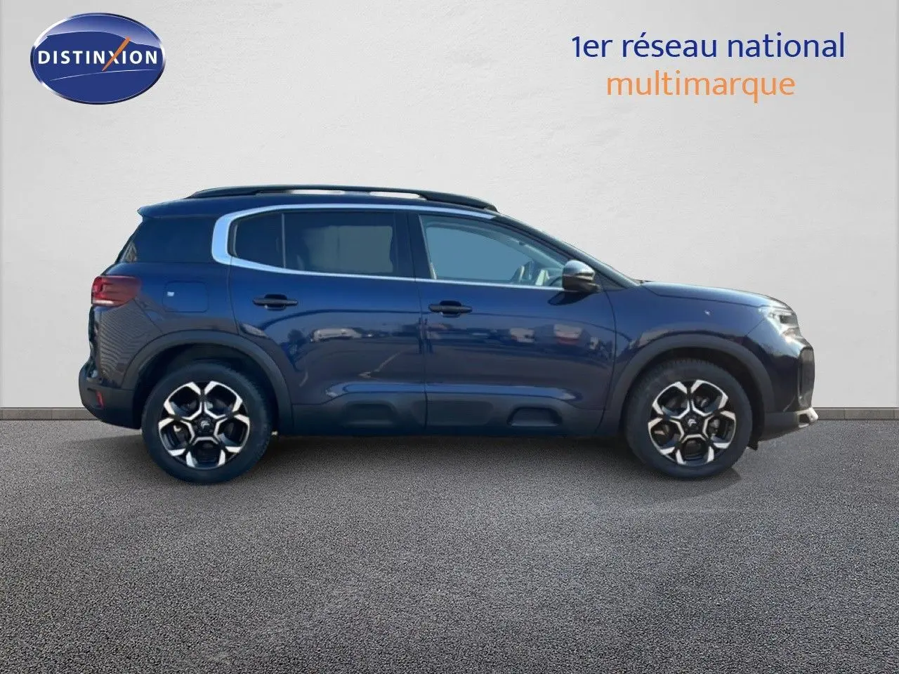 Profil droit d'un Citroën C5 Aircross 2025 bleu Eclipse Métal avec jantes alliage et barres de toit noires.